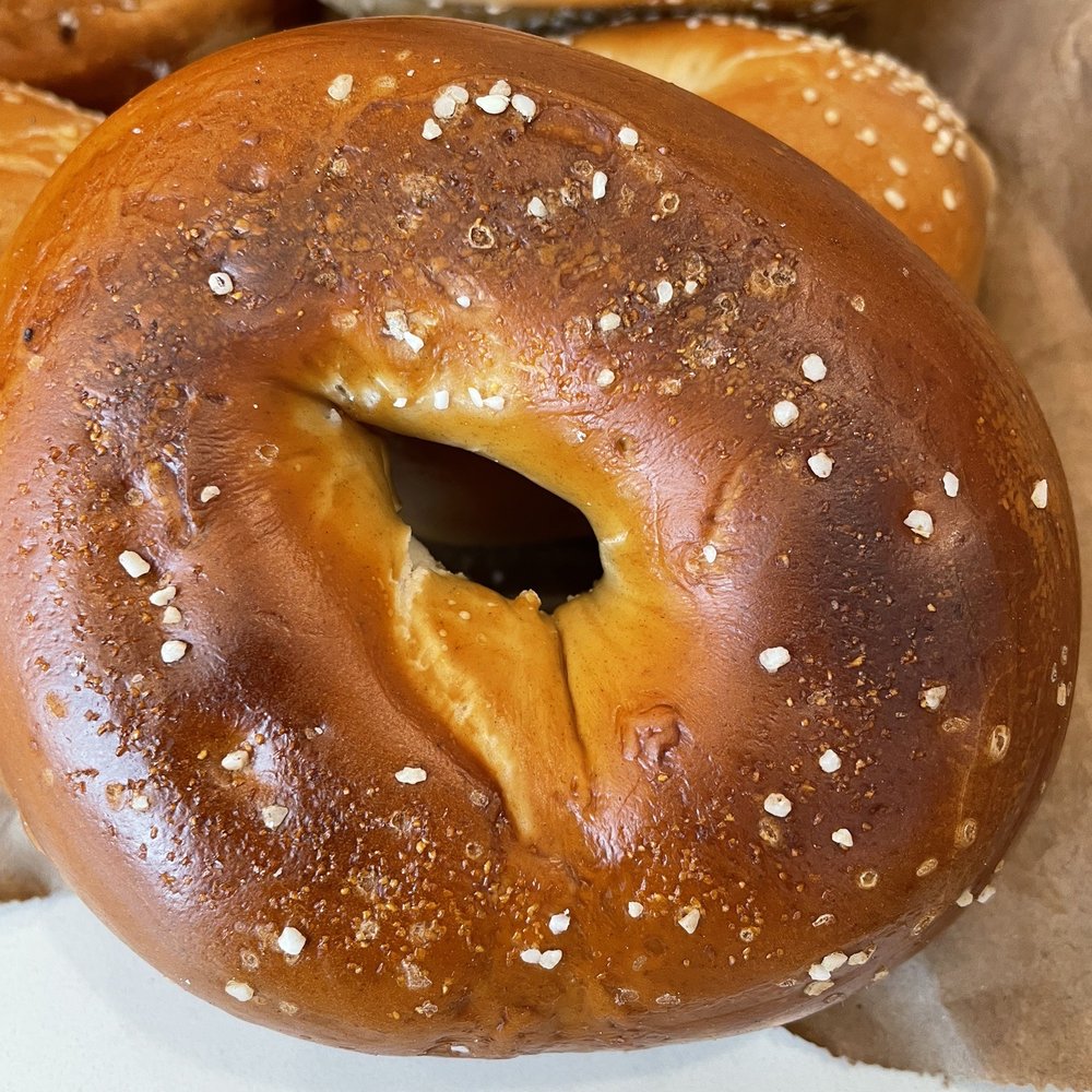 Lighthouse Bagels & Deli - Close-up of one of their fresh housemade bagels - Pretzel Bagel - Bagels Near Me - Corolla, North Carolina Lighthouse Bagels & Deli - Close-up of one of their fresh housemade bagels - Pretzel Bagel - Bagels Near Me - Corolla, North Carolina