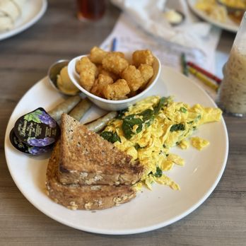 Daily Eats - Scramble eggs with spinach, mushroom and  tomatoes somewhere there lol turkey sausage and multi grain and tots ‍ - New American Near Me - Tampa, Florida