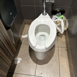 McDonald's - Poop smeared on baseboard tile next to toilet.
