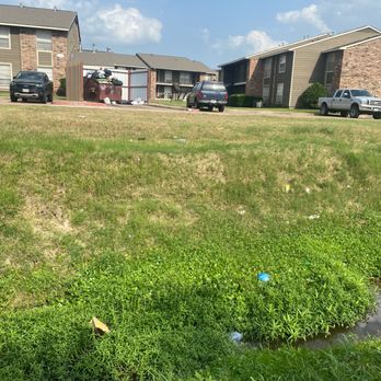 Pepper Tree - overflowing garbage going into the stream - Apartments Near Me - College Station, Texas
