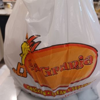 La Granja - a bag of chicken sitting on a counter - Peruvian Near Me - Miami, Florida