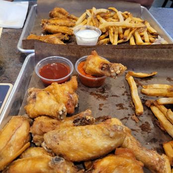 Mad Dawgs Public House - Meaty naked wings with a side of medium and Mad Dawg sauce on a side - Pubs Near Me - Pickering, Ontario Mad Dawgs Public House - Meaty naked wings with a side of medium and Mad Dawg sauce on a side - Pubs Near Me - Pickering, Ontario