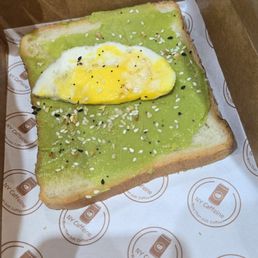 sad avocado toast, with half a cold egg that cost $2 extra
