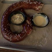 Photo of Mason Jar NYC - New York, NY, United States. Pretzel appetizer with mustard and cheese sauces (1/3 already eaten; sorry!)