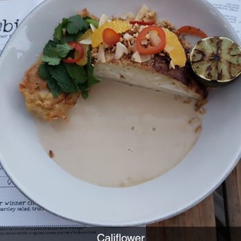 Nobie's - Roasted half cauliflower with a tom yum sauce, peppers and charred lime - New American Near Me - Houston, Texas Nobie's - Roasted half cauliflower with a tom yum sauce, peppers and charred lime - New American Near Me - Houston, Texas