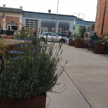 The Half Nelson - Socially distanced tables with planters as dividers. - Bars Near Me - Davenport, Iowa