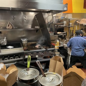 Buster's Cheesesteak - a man working in a commercial kitchen - American Near Me - San Francisco, California Buster's Cheesesteak - a man working in a commercial kitchen - American Near Me - San Francisco, California