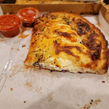 Uncle Gino’s Pizzeria - Supersized calzone stuffed w/ chicken, xtra cheese, olives, onions, garlic, and pineapples. Uncle Gino's is the best. - Pizza Near Me - Temecula, California Uncle Gino’s Pizzeria - Supersized calzone stuffed w/ chicken, xtra cheese, olives, onions, garlic, and pineapples. Uncle Gino's is the best. - Pizza Near Me - Temecula, California