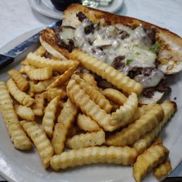 Philly Cheese steak sandwich and fries.