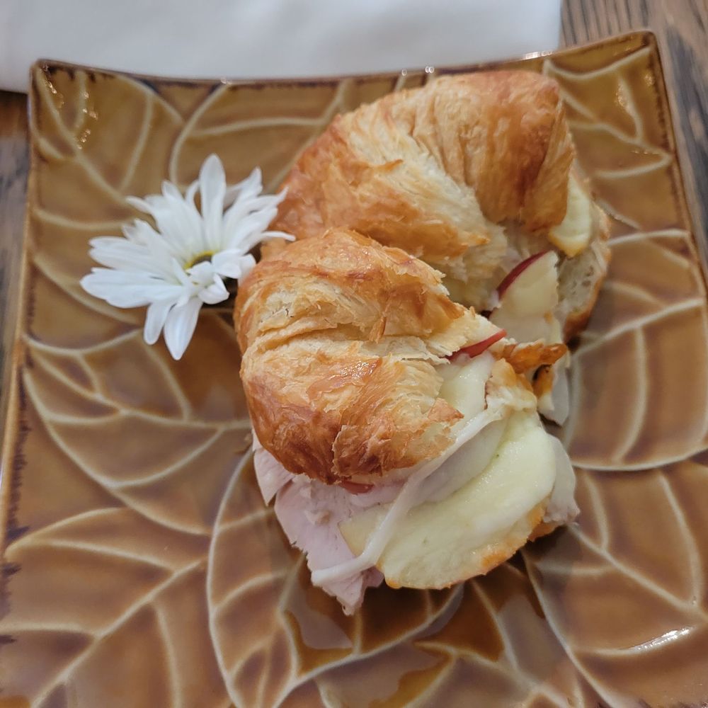 Flowers In the Attic - a croissant sandwich on a plate - Florists Near Me - Pittsburgh, Pennsylvania Flowers In the Attic - a croissant sandwich on a plate - Florists Near Me - Pittsburgh, Pennsylvania