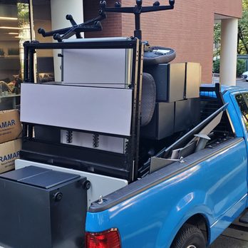 Easy Fast Clean - a blue pick up truck loaded with appliances - Snow Removal Near Me