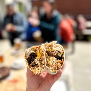 Kuya Bear Food - a hand holding a burrito - Food Trucks Near Me - Winston-Salem, North Carolina Kuya Bear Food - a hand holding a burrito - Food Trucks Near Me - Winston-Salem, North Carolina