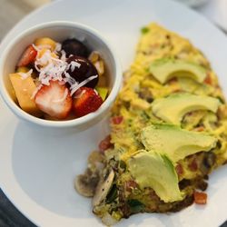 Early Riser Cafe - Three Egg Omelet with avocado, jalapeños, tomatoes, onions, and mushrooms. Side of fruit.