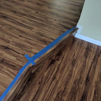 DJS Remodeling - a wood floor with tape - Flooring Near Me DJS Remodeling - a wood floor with tape - Flooring Near Me
