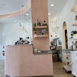 Chashni Cafe - The sugar/ milk station is on the top two shelves and self serve water is in the silver container on white sideboard