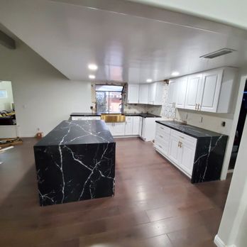 EJWinterStone - a kitchen with a marble island - Interior Design Near Me EJWinterStone - a kitchen with a marble island - Interior Design Near Me