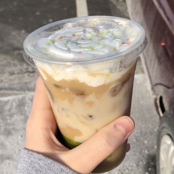 New Roots Coffee Cart - a hand holding a cup of iced coffee - Coffee & Tea Near Me - Manchester, New Hampshire New Roots Coffee Cart - a hand holding a cup of iced coffee - Coffee & Tea Near Me - Manchester, New Hampshire
