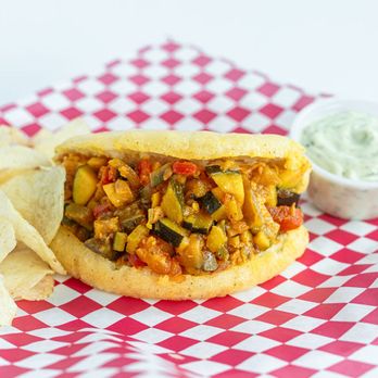 I Love Pig - Crispy arepa stuffed with a sautéed mix of eggplant, zucchini, onion, garlic, bell pepper, and tomato. A delicious vegetarian option! - Venezuelan Near Me - Flint, Michigan