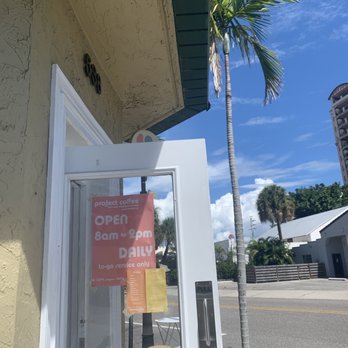 Project Coffee - Front door, palm tree, hour sign - Coffee & Tea Near Me - Sarasota, Florida Project Coffee - Front door, palm tree, hour sign - Coffee & Tea Near Me - Sarasota, Florida