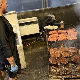 Steaks cooking on charcoal