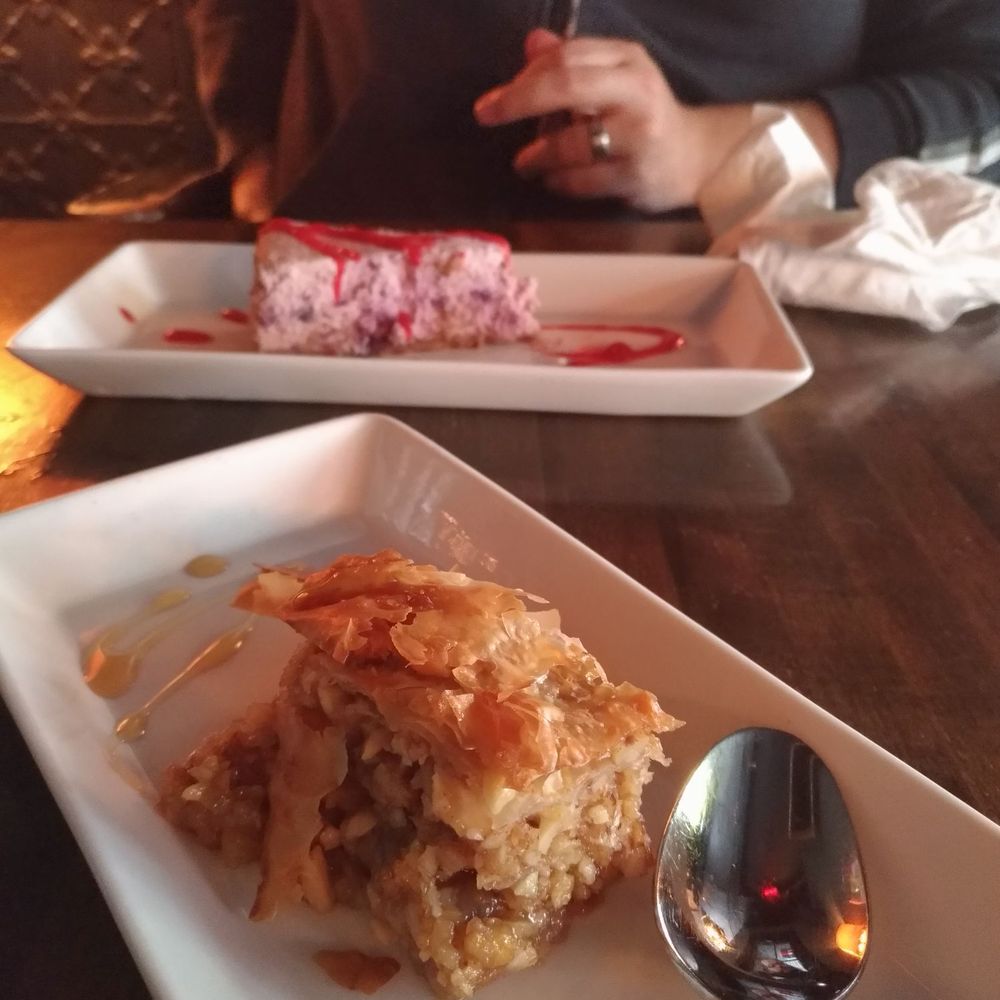 a plate of food and a spoon a plate of food and a spoon