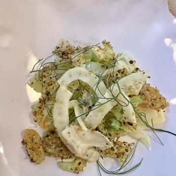 Margot - Celery & fennel salad - A celery and fennel salad with herbs, garnished with thin green leaves, served on a white plate. - New American Near Me - Brooklyn, New York