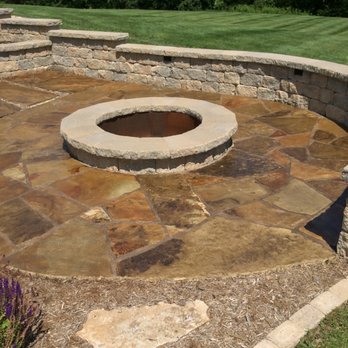 Penn Landscaping - a fire pit in the middle of a stone patio - Landscaping Near Me - Bloomington, Illinois Penn Landscaping - a fire pit in the middle of a stone patio - Landscaping Near Me - Bloomington, Illinois