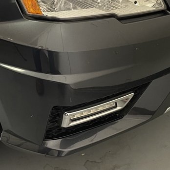 Colors On Parade - Hard to see in this photo that there's a deep scrape below the orange of the headlight and multiple serious scratches near the fog lamps. - Mobile Dent Repair Near Me Colors On Parade - Hard to see in this photo that there's a deep scrape below the orange of the headlight and multiple serious scratches near the fog lamps. - Mobile Dent Repair Near Me