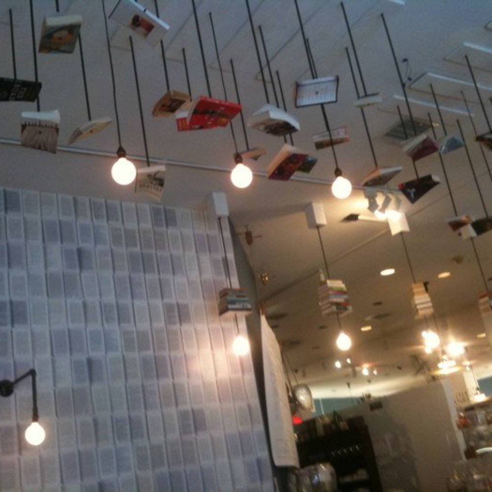 McNally Jackson - Books hang from the ceiling in te cafe and the wallpaper is mad of "book pages." - Bookstores Near Me - New York, New York McNally Jackson - Books hang from the ceiling in te cafe and the wallpaper is mad of "book pages." - Bookstores Near Me - New York, New York