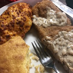Schnitzel with twice baked potatoes and corn bread.