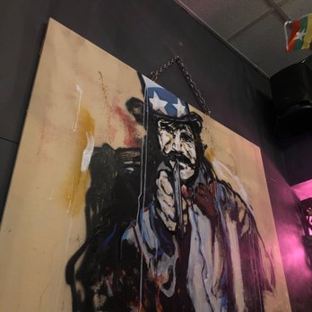 The Points LES - a painting of a man holding a gun - Tapas Bars Near Me - New York, New York