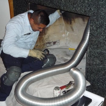 The Energy House - Ducting hoses being fed down the chimney... - Fireplace Services Near Me - Campbell, California
