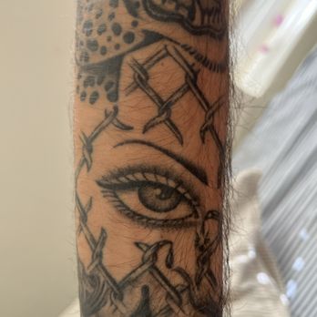 Seventh Serpent Tattoo - Healed eyeball looking through a chain link fence from Vic - Tattoo Near Me - San Diego, California Seventh Serpent Tattoo - Healed eyeball looking through a chain link fence from Vic - Tattoo Near Me - San Diego, California