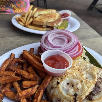 Paradise Grill - Medium Rare Burger with a fried egg and Sweet Potato fries Across is a Turkey Bacon Avocado melt - New American Near Me - Nokomis, Florida