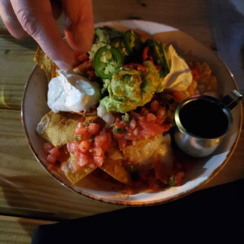 Chelsea's Kitchen - Nachitos appetizer and somebody, ahem, photo bombing the food - New American Near Me - Phoenix, Arizona