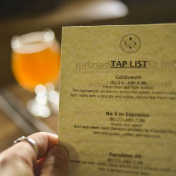 EB Coffee & Pub - a hand holding a menu - Coffee & Tea Near Me - Caledonia, Michigan