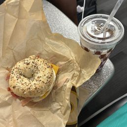 Bacon egg and cheese bagel sandwich and iced tea Bacon egg and cheese bagel sandwich and iced tea