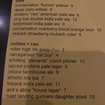 The Eddy - A printed beer menu lists draft beers and bottled options, including various styles such as pilsner, pale ale, and stout, with prices ranging from $3 to $12. The menu is organized into sections for draft beers and bottles with cans, and includes specific beer names and sizes. - Cocktail Bars Near Me - Providence, Rhode Island
