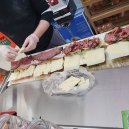 a woman cutting a sandwich a woman cutting a sandwich