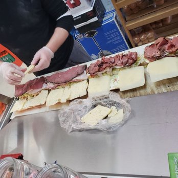 Live Oak Pizza & Deli - a woman cutting a sandwich - Pizza Near Me - Boulevard, California Live Oak Pizza & Deli - a woman cutting a sandwich - Pizza Near Me - Boulevard, California