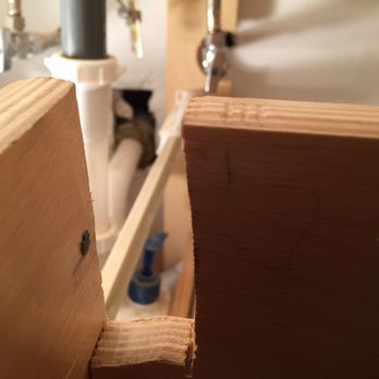 Archway Home Remodeling - Underneath the sink --the holes in the wall & the cut up drawer! - General Contractors Near Me - Chicago, Illinois Archway Home Remodeling - Underneath the sink --the holes in the wall & the cut up drawer! - General Contractors Near Me - Chicago, Illinois