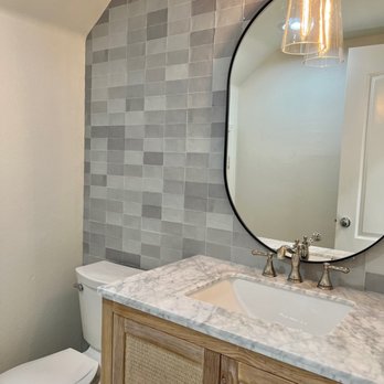 Avalon Construction Group - a bathroom with a sink, toilet, and mirror - General Contractors Near Me Avalon Construction Group - a bathroom with a sink, toilet, and mirror - General Contractors Near Me