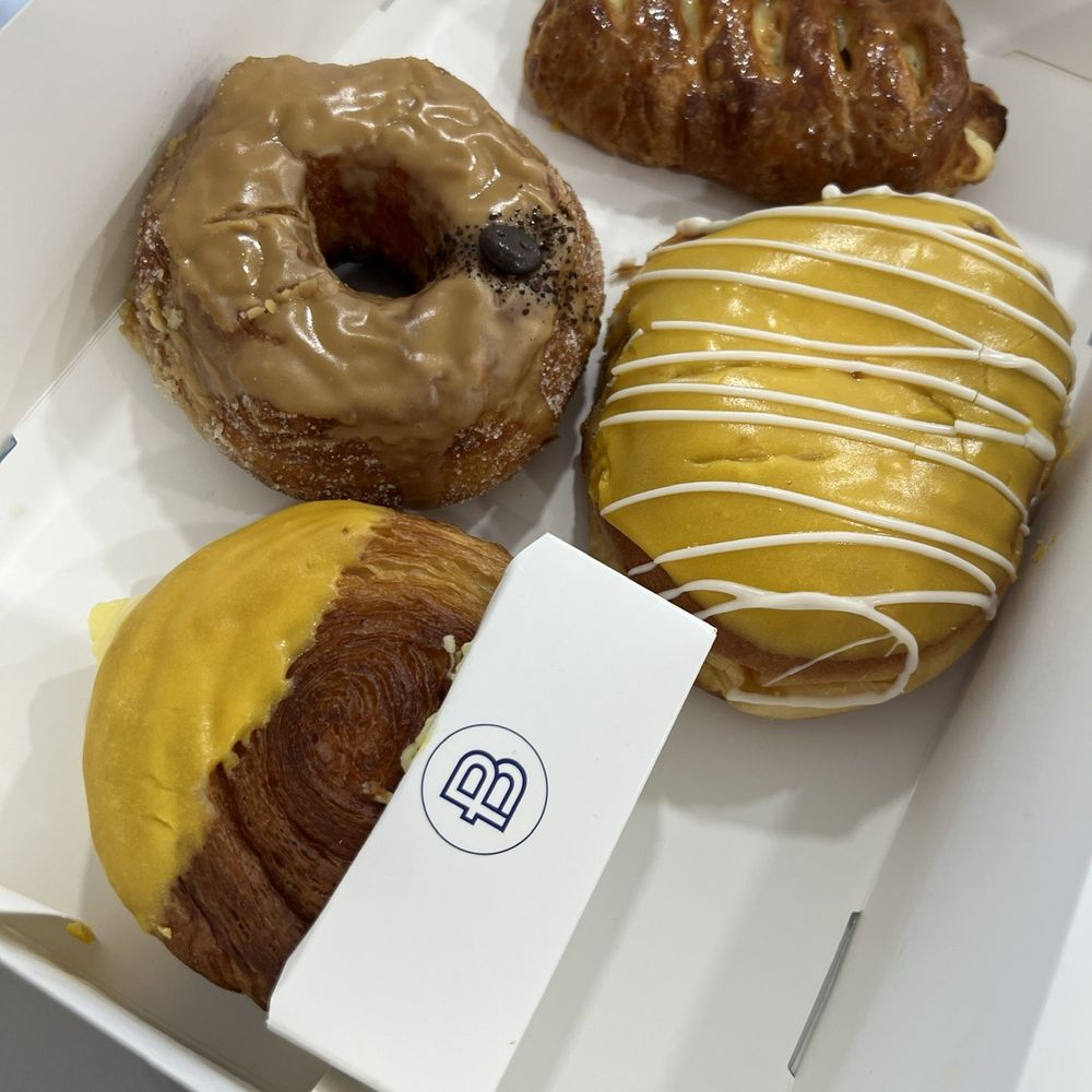 Assortment of Pastries, Lemon Custard King Cream Donut, Lemon Supreme Croissant, Coffee Croissant Donut, Blueberry Cream Cheese Pastry Assortment of Pastries, Lemon Custard King Cream Donut, Lemon Supreme Croissant, Coffee Croissant Donut, Blueberry Cream Cheese Pastry