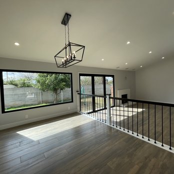 VP Design & Construction - a view of a living room with hardwood floors and a chandelier - General Contractors Near Me VP Design & Construction - a view of a living room with hardwood floors and a chandelier - General Contractors Near Me