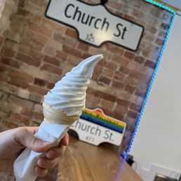 a person holding an ice cream cone