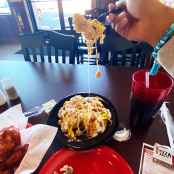 Greenbrier Pizza & Pub - a person holding a fork over a plate of food - Pizza Near Me - Greenbrier, Tennessee Greenbrier Pizza & Pub - a person holding a fork over a plate of food - Pizza Near Me - Greenbrier, Tennessee