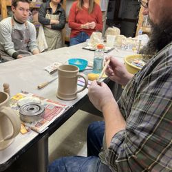 Village Potters Guild - Instructor demonstrates attaching handle to a mug