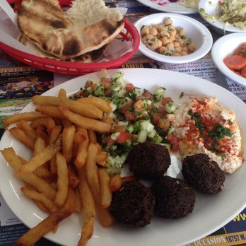 Etzel Itzik Deli - Falafel plate with salads and pita in the back - Delis Near Me - Miami, Florida Etzel Itzik Deli - Falafel plate with salads and pita in the back - Delis Near Me - Miami, Florida