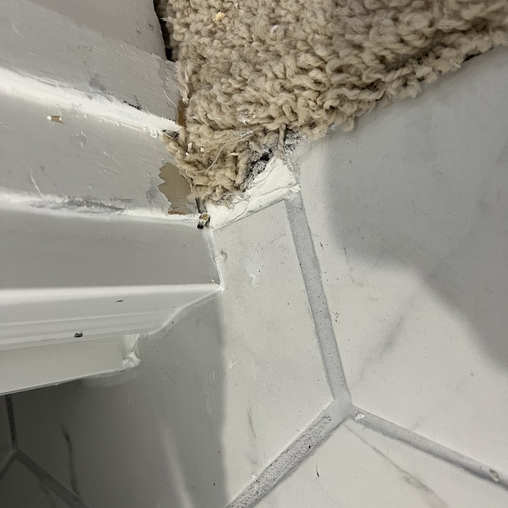 Guerra and Sons Contracting - Poor carpet to tile transition. Used a clump of silicone - General Contractors Near Me Guerra and Sons Contracting - Poor carpet to tile transition. Used a clump of silicone - General Contractors Near Me