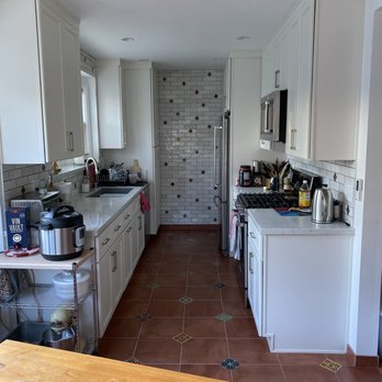 A Plus Design and Remodeling - Our kitchen with colored accent tiles on the ground and matching small ones (placed randomly) on the backsplash that wraps around the room - General Contractors Near Me - Van Nuys, California